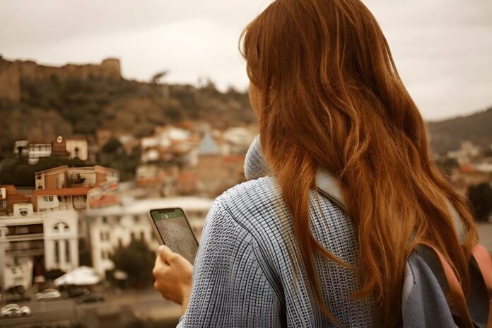 Smart travel Traveler using smartphone map app while exploring a scenic destination.