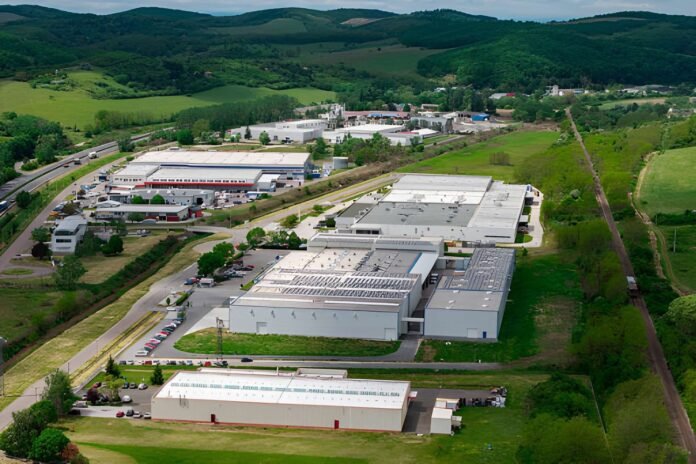 Economic Diversification Modern industrial park with factories, solar panels, and office buildings.