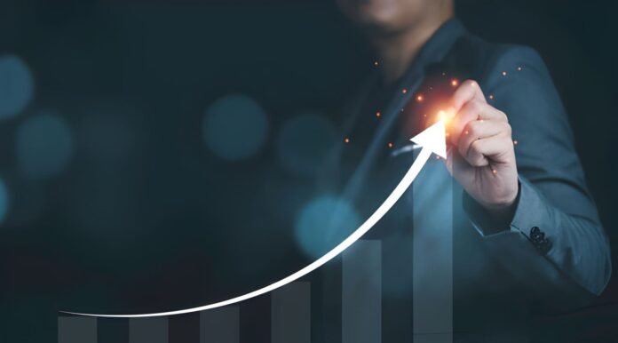 A worker using advanced technology with rising productivity charts.