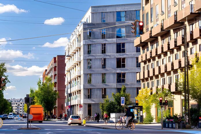 transit oriented communities Modern transit-oriented community with residential buildings, public transportation, and walkable urban spaces.